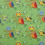 Orange & green owls on green quilting fabric