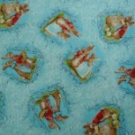 Two rabbits on blue quilting fabric