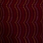 Tracks on burgundy aboriginal print fabric 