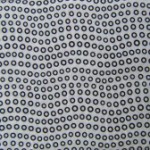 Small black circles on white fabric